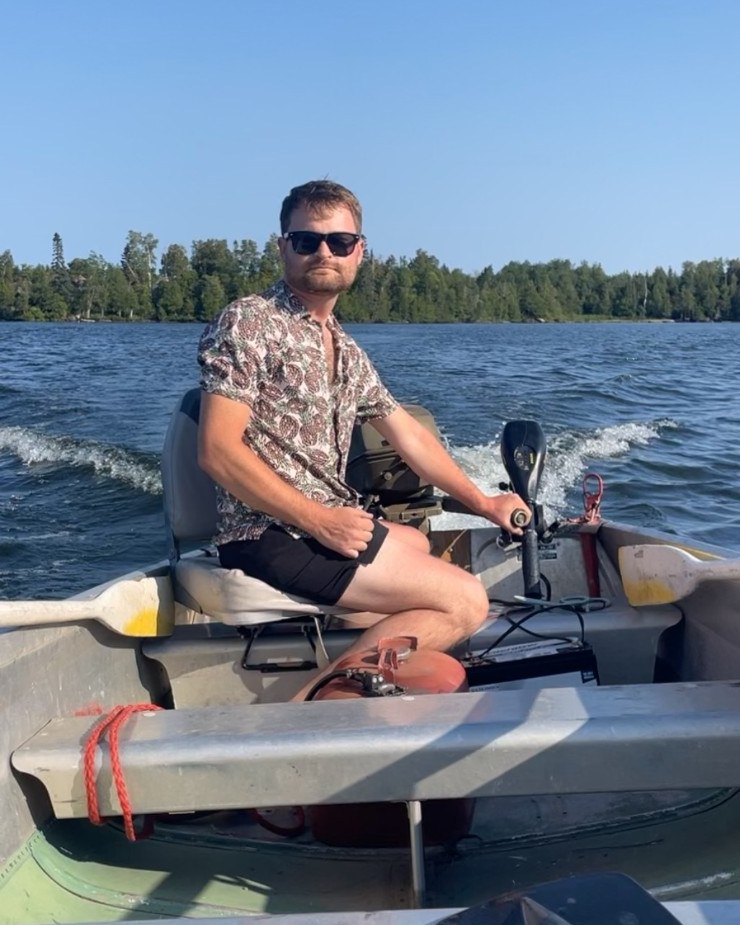 Josh Gloe driving a boat on a Minnesota lake